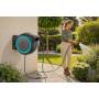 Wall-mounted hose reel with hose for watering garden plants outdoors